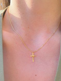 This minimalistic Cross Necklace features a small gold cross with a high polish finish that sits on a delicate 14K Yellow Gold chain. It's perfect for layering with your favorites or styled solo for a classic look. Necklace Length: 16 Inches *with a 2-inch extension Pendant Length: 1.5 cm Pendant Width: 1 cm Chain Type: Flat Cable Clasp: Lobster Metal: 14K Yellow Gold (stamped) Everyday 14k Yellow Gold Cross Necklace, Minimalist 14k Gold Crucifix Jewelry, Minimalist 14k Gold Crucifix Necklace, Yellow Gold Crucifix Necklace With Delicate Chain, Dainty Yellow Gold Cross Necklace For Everyday, Minimalist 14k Gold Crucifix Cross Necklace, Everyday 14k Gold Cross Pendant Necklace, Dainty 14k Yellow Gold Cross Necklace, Daily 14k Gold Cross Pendant Necklace