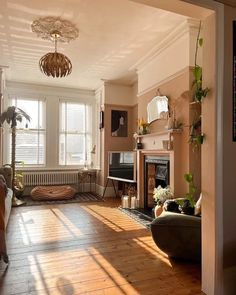 a living room with wood floors and a fire place