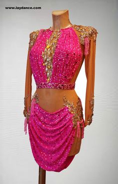 a pink dress with gold sequins and beads on the top is displayed in front of a white background