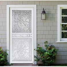 a white door is open in front of a house