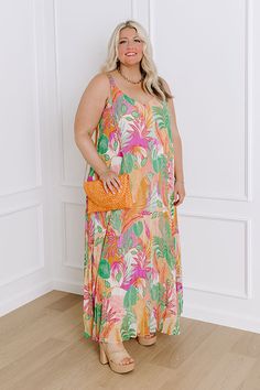 - Find me in the cabana in this tropical maxi! Embrace the carefree spirit of paradise with its flowing silhouette and cheerful hues, perfect for sun-soaked adventures or leisurely strolls along the beach. Let the playful patterns and airy design transport you to a world of endless sunshine and tropical bliss. - Pleated chiffon material with a pink, purple, ivory, orange, and green hued tropical botanical print - A built-in chiffon lining - A v-cut neckline and back - Adjustable spaghetti straps Beachy Floral Print Maxi Dress For Summer, Beachy Floral Print Maxi Dress For Summer Outings, Beachy Floral Maxi Dress For Summer, Multicolor Floral Print Maxi Dress For Summer Outings, Vibrant Print Sundress For Beach Season, Breezy Floral Print Maxi Dress For Vacation, Tropical Multicolor Sundress For Summer Outings, Multicolor Tropical Print Sundress For Summer Outings, Beachy Sundress With Tropical Print For Beach Season