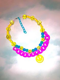 Grin it to win it in this handmade, one-of-a-kind Happy Face Place Necklace from The Tote Trove! Slip it on with your favorite sweater, tee, or dress for a friendly finishing touch.   I created the Happy Face Place Necklace by first stringing colorful and smiley face plastic beads along silver-tone wire.  Finally, I attached a chunky pink plastic chain with a happy face charm.  Kitschy and kawaii, the Happy Face Place Necklace goes the extra mile for smiles! :) The Happy Face Place Necklace measures approximately 5.5" from the clasp to the center beads when closed and fastens with a silver-tone lobster claw clasp.  When unclasped, it measures about 15" long.  The Happy Face Place Necklace features a 3" turquoise plastic extender chain, making adjustments convenient. All of my work is creat Face Necklace, Chain Making, Extra Mile, Pink Plastic, Favorite Sweater, Happy Face, Plastic Beads, Smiley Face, The Happy