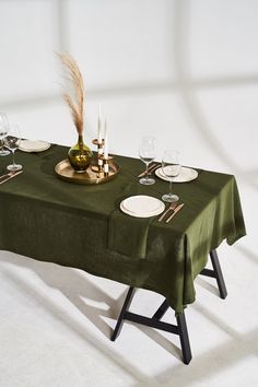 "Exquisite, natural handmade softened linen tablecloth finished with mitered corners provides a charming look to any table and dining room. Choose between 22 different colors that will surely bring some uniqueness and festivity to your current interior. Soft and light tablecloth works great for everyday table and for family celebrations as well. COMPOSITION: 100% softened Lithuanian linen. SIZE: square 53\"x53\"(135x135cm); round 53\"(135cm); 53\"x72\"(135x182cm); 53\"x84\"(135x213cm); 53\"x96\" Table Cloth Linen, Green Table Cloth Setting, Green Round Table Cloth, Restaurant Table Cloth, Dining Room Tablecloth, Product Shooting, Green Tablecloth, Christmas Table Linen, Christmas Tablecloth