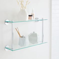 two glass shelves with toothbrushes and soap dispensers