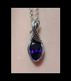 This pendant is made with a dark purple cubic zirconia stone that is wrapped in solid sterling silver which has been oxidized and polished for an antiqued look.  This pendant is a little under 1.5 inches tall.  Please see photos for exact measurement.  This pendant will include a complimentary 18 inch stainless steel necklace and it will arrive in a gift box. Formal Sterling Silver Wire Wrapped Jewelry, Purple Oxidized Jewelry For Gift, Purple Sterling Silver Wire Wrapped Jewelry, Hand Forged Purple Jewelry Gift, Sterling Silver Teardrop Pendant Wire Wrapped Jewelry, Sterling Silver Wire Wrapped Teardrop Pendant Jewelry, Sterling Silver Teardrop Pendant Jewelry Wire Wrapped, Classic Purple Pendant Jewelry, Gothic Hand Forged Sterling Silver Jewelry