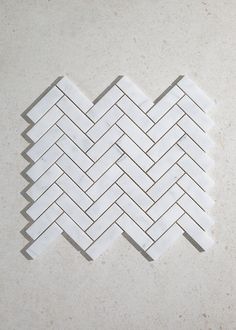 a white tile pattern on the ground with no one in it or someone is looking at it