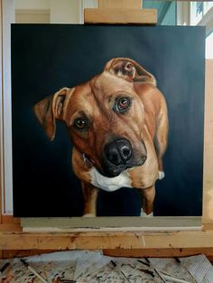 a painting of a dog is on the easel