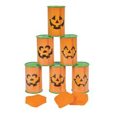 a stack of orange cups with pumpkin faces on them