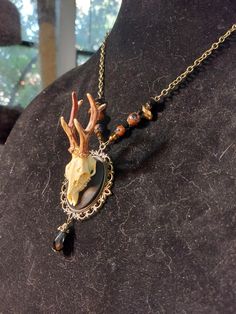 Look at this gorgeous pendant  Perfect hand sculpted replica of a deer skull made out of resin on a cameo plus brass setting with brown goldstone beads and jet black faceted crystal beads  total length ( without pendant) 28 inches , adjustable, fastens with lobster clasp Skull Cameo, Antler Pendant, Deer Skull, Deer Skulls, A Deer, Cameo Necklace, Skull Necklace, Skull Pendant, Faceted Crystal