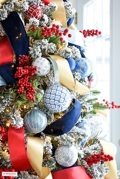 a decorated christmas tree with red, white and blue ornaments