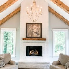 a living room with two couches and a fire place in it's center