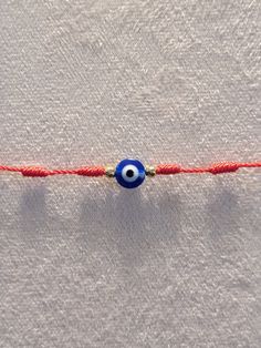 Adjustable 7 knot Evil Eye bracelet handmade in Las Vegas.  Introducing our Hand-Woven Red String Kabbalah Bracelet, a timeless blend of tradition and style. Crafted with care, each bracelet is meticulously handmade with 7 knots. Adorned with the powerful symbol of the Evil Eye, this bracelet serves as a protective talisman, guarding against negative energy and offering a sense of security. The adjustable design allows for a comfortable fit on any wrist, making it suitable for all.  Ideal for gifting, this Lucky Amulet Bracelet carries profound symbolism, making it a thoughtful gesture for loved ones. Protective Talisman, Kabbalah Bracelet, Amulet Bracelet, Red String, Eye Bracelet, Evil Eye Bracelet, Bracelet Handmade, Negative Energy, Handmade Bracelets