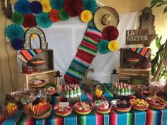 a colorful table topped with lots of food