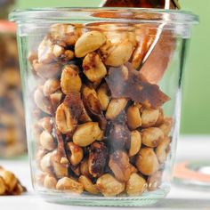 a glass jar filled with nuts on top of a table