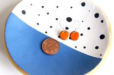 Small but bold these bright orange round enamel earrings are sure to stand out in any crowd!Measuring 11mm diameter these little earrings are a lot smaller than the iamrachel best selling 16mm earrings but with the same rich enamel colour and fantastic quality finish.The small round earrings are made by firing enamel powder onto copper in a kiln at a temperature of over 820 degrees.These enamel earrings are part of iamrachel's mini dot jewelry series handmade by Rachel in her Somerset studio. Th Everyday Round Enamel Earrings, Orange Enamel Earrings For Gifts, Orange Enamel Earrings For Gift, Orange Enamel Earrings As A Gift, Orange Minimalist Earrings For Everyday, Minimalist Orange Earrings For Everyday, Everyday Minimalist Orange Earrings, Nickel-free Orange Earrings For Everyday Wear, Nickel Free Orange Earrings For Everyday