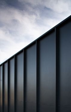 the side of a building that is made out of metal and has been painted black