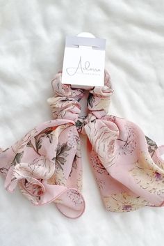 Floral Scrunchie ScarfAdd a romantic floral flare to your outfit! Delicate with feminine colors. Transform your look and exude sophistication with our Floral Scrunchie Scarf. This delicate and feminine accessory adds a romantic touch to any outfit, making a statement that is both elegant and stylish. The soft floral patterns and pastel tones create a luxurious feel, elevating your style to new heights. Step into a world of refined fashion with our Floral Scrunchie Scarf. Details: features: • Bow Luxury Pink Elegant Scarf, Luxury Elegant Pink Scarf, Scrunchie Scarf, Feminine Colors, Floral Scrunchie, Chic Hair, Refined Fashion, Soft Floral, Outfit Making