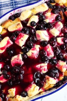 a blue and white dish filled with fruit