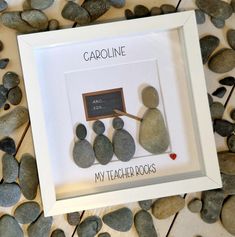 a white frame with some rocks and a chalkboard on it that says capolinne my teacher rocks