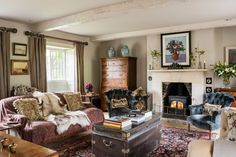 a living room filled with furniture and a fire place