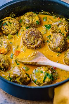 a pan filled with meatballs covered in sauce