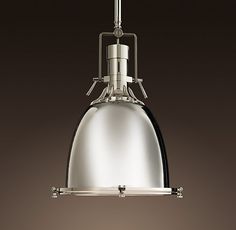 an image of a light that is hanging from the ceiling in front of a dark background