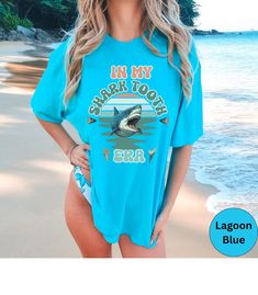 Shark Tooth Hunting Retro Shirt, in My Shark Tooth Era Comfort Colors Tshirt, Summer Beach Tee, Sharks Teeth, Fossil Hunting T Shirt - Etsy Funny Short Sleeve T-shirt For Beach, Blue Summer T-shirt With Funny Text, Blue Tops With Funny Text For Summer, Blue Funny Text T-shirt For Summer, Blue Summer Top With Funny Text, Funny Beach T-shirt With Crew Neck, Funny Letter Print Tops For Vacation, Funny Beach T-shirt Short Sleeve, Funny Blue T-shirt For Summer