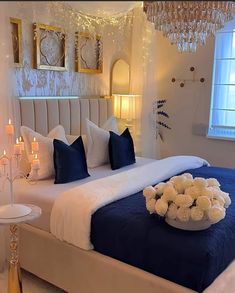 a bed with white flowers and blue sheets in a bedroom decorated for christmas or new year's eve