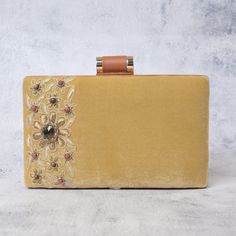 Elevate your style with our opulent Beige Hand Embroidered Velvet Clutch Bag, a true embodiment of sophistication and luxury. This exquisite rectangle-shaped clutch is meticulously handcrafted to perfection. Size(cm): 20X12X4 Utility: Shoulder Bag Material: Velvet Fabric & Metal Thread Stones: Multi Sapphire,Tiger Eye & Sand stone Base Color: Beige Pockets: Single The focal point of this clutch is the intricate hand embroidery, which features a stunning array of MULTI SAPPHIRE, TIGER EYE, and SAND gemstones. Each gemstone is carefully selected and skillfully arranged to create a mesmerizing pattern that catches the light and dazzles onlookers. The lustrous beige velvet adds a touch of elegance and tactility to this accessory. It's not just a clutch; it's a work of art that complements your Glamorous Embroidered Bags For Reception, Glamorous Embroidered Clutch For Festive Occasions, Luxury Embellished Clutch For Festive Occasions, Elegant Embellished Clutch For Reception, Glamorous Embroidered Clutch For Reception, Festive Embellished Bags For Reception, Designer Embellished Clutch For Reception, Elegant Embellished Clutch For Festive Season, Festive Embellished Evening Clutch