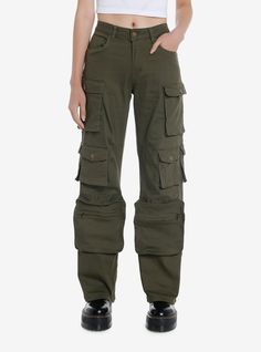 a woman wearing green cargo pants and black shoes with her hands in her pockets,