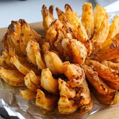 some fried food is sitting on a piece of tin foil and ready to be eaten