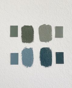 several shades of blue and green paint on a white wall with the same color swatches