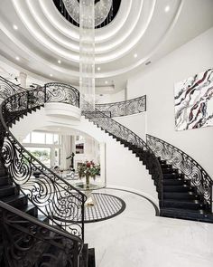 a spiral staircase in a large white house