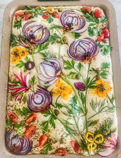 a pan filled with vegetables on top of a table