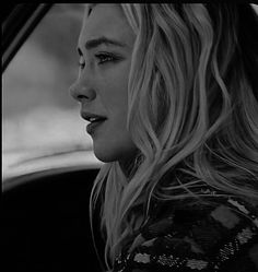 a woman sitting in the passenger seat of a car