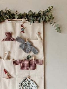 a wall hanging with clothes and shoes on it