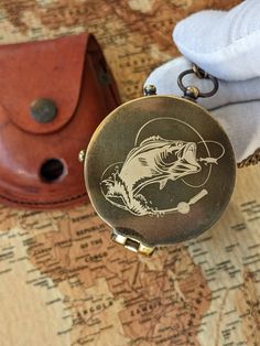 a pocket watch sitting on top of a map