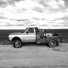 a black and white photo of a pickup truck