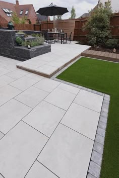 an outdoor patio with grass and stone steps