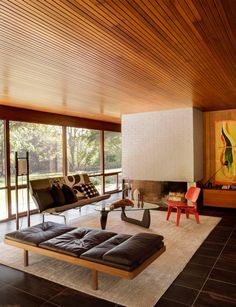 a living room with couches, tables and chairs in front of sliding glass doors