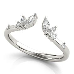 a white gold ring with three pear shaped diamonds