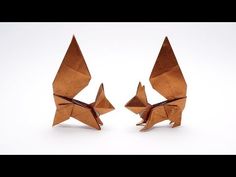 two brown origami birds sitting next to each other