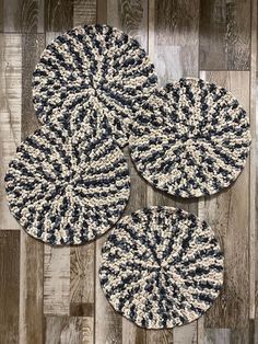 three black and white rugs sitting on top of a wooden floor