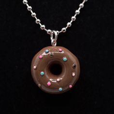 a chocolate doughnut with sprinkles is on a chain