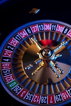 a close up of a casino wheel with numbers and symbols on the front, as well as an arrow