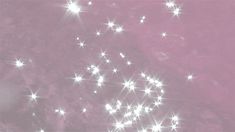 a pink background with white stars in the middle and light shining down on it's surface