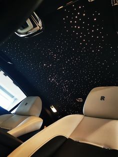 the interior of a car with stars painted on the ceiling