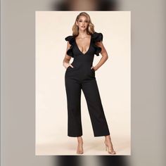 Statement Sleeve Jumpsuit Features A Daring V Neck, Structured Ruffle Sleeves, And A Fitted Waistband For A Shape Defining Silhouette That Sits Atop Straight Leg Bottoms. Elegant Ruffled Jumpsuits And Rompers For Date Night, Chic Overall Jumpsuits And Rompers For Parties, Chic Black Jumpsuits And Rompers For Brunch, Chic Black Jumpsuit For Brunch, Elegant Ruffled Jumpsuits And Rompers For Brunch, Glamorous Fitted Jumpsuits And Rompers With Ruffles, Glamorous Summer Workwear Jumpsuits, Chic Party Bodysuit With Ruffles, Chic Party Bodysuit