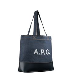 - Tote bag in Japanese canvas.- Two large handles to carry the bag by hand or on the shoulder.- Large panel in smooth leather at bottom of bag.- Reinforced base.- Interior zip pocket.- Large A.P.C. logo in front.- Caramel topstitching on the denim. Faux Leather Bag, Exclusive Clothing, C Logo, Japanese Denim, Backpack Tote Bag, Dark Navy Blue, Tote Backpack, Weekender Bag, Dark Navy