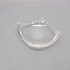 a clear plastic mouthpiece on a white surface with no visible objects in the background